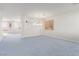 Spacious carpeted living room with neutral walls, a ceiling fan, and natural lighting at 774 Wigan Pier Dr, Henderson, NV 89002