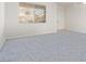 Bright living room with natural light from the large window with blue carpet at 774 Wigan Pier Dr, Henderson, NV 89002