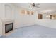 Open-concept living room with fireplace, ceiling fan, and ample space for relaxation at 774 Wigan Pier Dr, Henderson, NV 89002