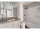 A bathroom featuring updated cabinets and granite countertops and a shower at 8600 W Charleston Blvd # 2108, Las Vegas, NV 89117
