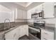 Updated kitchen featuring stainless steel appliances, granite countertops, and white cabinets at 8600 W Charleston Blvd # 2108, Las Vegas, NV 89117
