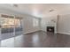 Cozy living room features a fireplace, sliding doors to the balcony, a window, and wood-look floors at 8600 W Charleston Blvd # 2108, Las Vegas, NV 89117