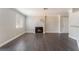 Bright living room with fireplace, wood-look floors, and view of the front door at 8600 W Charleston Blvd # 2108, Las Vegas, NV 89117