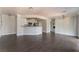 Open-concept living room with wood floors, ceiling fan, breakfast bar, and views of the kitchen at 8600 W Charleston Blvd # 2108, Las Vegas, NV 89117