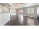 Spacious living room with ceiling fan, sliding glass doors to the balcony, and wood-look flooring at 8600 W Charleston Blvd # 2108, Las Vegas, NV 89117