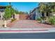 Gated driveway features a brick-paved drive, desert landscaping, and privacy at , Las Vegas, NV 89131