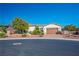 Charming single-story home with desert landscaping, a brick driveway, and a two-car garage at , Las Vegas, NV 89131