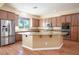 Open kitchen with a large island, stainless steel appliances, and wooden cabinets at , Las Vegas, NV 89131