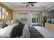 Relaxing main bedroom featuring a ceiling fan, window, sliding glass doors, and access to the backyard at , Las Vegas, NV 89131