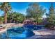 Backyard pool features a rock waterfall, spa, and lush landscaping, creating a private oasis at , Las Vegas, NV 89131