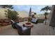 Backyard oasis featuring a fire pit, desert landscaping, and outdoor seating at 8824 Martin Downs Pl, Las Vegas, NV 89131