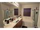 Bright bathroom featuring double sinks, a soaking tub, and a separate glass-enclosed shower, creating a luxurious feel at 8824 Martin Downs Pl, Las Vegas, NV 89131