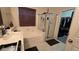 Bathroom with a combined tub and shower with glass doors, plus a view into a closet space, providing practicality and comfort at 8824 Martin Downs Pl, Las Vegas, NV 89131