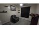 Cozy bedroom with recliner, soft carpet, shelving and dark curtain at 8824 Martin Downs Pl, Las Vegas, NV 89131