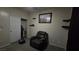Comfortable bedroom with recliner, soft carpet, and shelf storage at 8824 Martin Downs Pl, Las Vegas, NV 89131