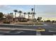 Silverstone Ranch community entrance featuring a pergola, landscaping, and stone accents, offering a welcoming street view at 8824 Martin Downs Pl, Las Vegas, NV 89131