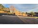 Community entrance sign with mature landscaping and a welcoming bench at 8824 Martin Downs Pl, Las Vegas, NV 89131
