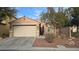 Charming single-story home with a two-car garage, neutral stucco, and well-maintained desert landscaping at 8824 Martin Downs Pl, Las Vegas, NV 89131