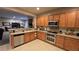 Well-lit kitchen featuring stainless steel appliances and wood cabinetry at 8824 Martin Downs Pl, Las Vegas, NV 89131