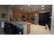 Functional kitchen featuring ample wood cabinetry, stainless steel appliances, and a breakfast bar at 8824 Martin Downs Pl, Las Vegas, NV 89131