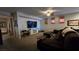 Inviting living room featuring a comfortable brown sofa, neutral walls and bright recessed lighting at 8824 Martin Downs Pl, Las Vegas, NV 89131
