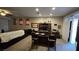 Large, carpeted home office with a full wall of built-ins, a large executive desk, and sliding glass door access at 8824 Martin Downs Pl, Las Vegas, NV 89131