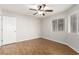 Comfortable bedroom with wood floors, bright windows, and modern ceiling fan at 8920 Litchfield Ave, Las Vegas, NV 89134