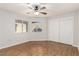 Bright bedroom with natural light, ceiling fan, wood floors, and closet for organized living at 8920 Litchfield Ave, Las Vegas, NV 89134