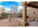 Picturesque courtyard featuring a multi-tiered fountain, stone accents, and desert landscaping for a serene outdoor space at 8920 Litchfield Ave, Las Vegas, NV 89134