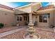 Inviting courtyard view with a decorative fountain, seating, and desert-style landscaping, creating a peaceful outdoor retreat at 8920 Litchfield Ave, Las Vegas, NV 89134