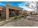Cozy covered patio with ceiling fan and stone landscaping in the backyard of this single story home at 8920 Litchfield Ave, Las Vegas, NV 89134