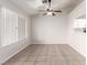Bright dining area with tile flooring, a ceiling fan, and natural light with a view of the backyard at 8920 Litchfield Ave, Las Vegas, NV 89134