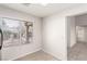 Bright dining area featuring tile flooring, backyard views, and access to the hallway at 8920 Litchfield Ave, Las Vegas, NV 89134