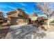 Attractive single-story home with an attached garage, long driveway, and desert landscaping against a beautiful blue sky backdrop at 8920 Litchfield Ave, Las Vegas, NV 89134