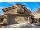Frontal view of the garage, showcasing its textured doors and the architectural detail above, set against a clear blue sky at 8920 Litchfield Ave, Las Vegas, NV 89134