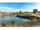 Scenic view of a golf course with blue skies reflected in a small lake within a beautiful community at 8920 Litchfield Ave, Las Vegas, NV 89134