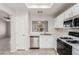 Bright kitchen features white cabinets, stainless steel appliances, and a tile floor at 8920 Litchfield Ave, Las Vegas, NV 89134
