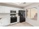 Bright kitchen features white cabinets, tile floors, and modern appliances at 8920 Litchfield Ave, Las Vegas, NV 89134