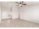 Spacious living room with neutral tile flooring, ceiling fan, and ample natural light at 8920 Litchfield Ave, Las Vegas, NV 89134