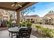 Cozy covered patio with seating area and charming landscaping at 8920 Litchfield Ave, Las Vegas, NV 89134