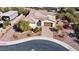 Aerial view of the home showing lush landscaping, tiled roof, paver driveway, and a backyard pool at , Las Vegas, NV 89131