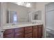 Bathroom featuring double sink vanity, large mirror, and white tiled shower and separate toilet at , Las Vegas, NV 89131