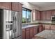 Well-lit kitchen featuring stainless steel appliances, granite countertops, and wooden cabinets at , Las Vegas, NV 89131