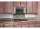 Kitchen close-up showcasing granite countertops, a stovetop, and wooden cabinets with stainless hardware at , Las Vegas, NV 89131