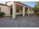 Covered patio with large support columns, brick flooring, ceiling fan, and landscaped backyard at , Las Vegas, NV 89131