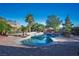 Backyard pool features rock waterfall, spa, mature trees, and brick patio at , Las Vegas, NV 89131