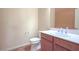 Powder room with tile floors, cherry vanity, modern fixtures, and decorative mirror at , Las Vegas, NV 89131