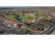 Aerial shot of neighborhood with a golf course, ponds, mature trees, and well maintained roads, highlighting the community's amenities at 10709 Brinkwood Ave, Las Vegas, NV 89134