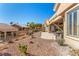 Well-manicured backyard with a covered patio and desert landscaping at 10709 Brinkwood Ave, Las Vegas, NV 89134