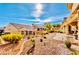 Beautiful backyard with lush desert landscaping, patio, and views of neighboring homes at 10709 Brinkwood Ave, Las Vegas, NV 89134